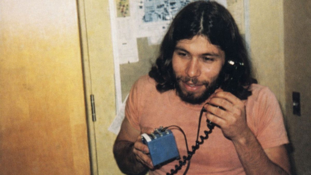 Steve Wozniak using a blue box, a device associated with phone phreaking and early hacker culture.
